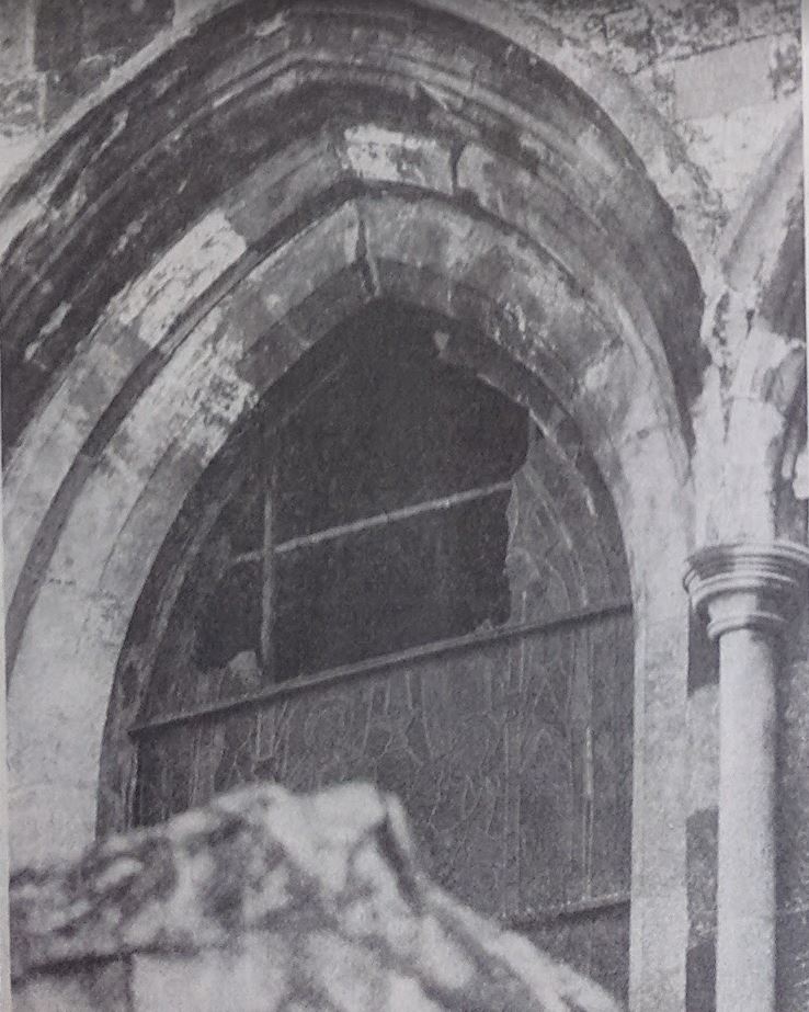 A damaged stained glass window on the west wall of Chichester Cathedral